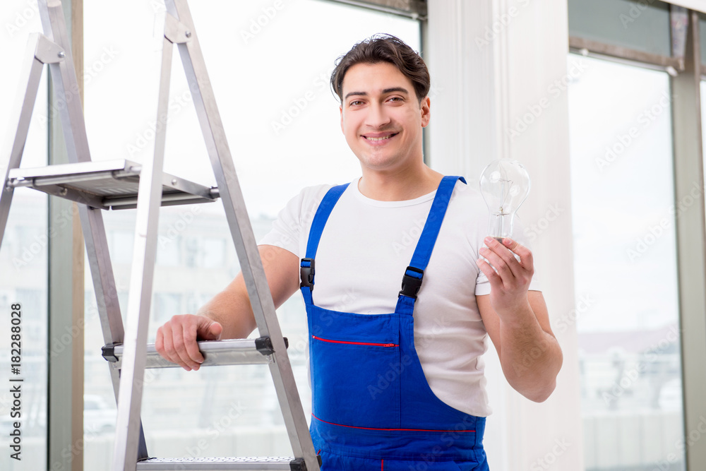 Contractor preparing the change the light bulb Contractor preparing the change the light bulb