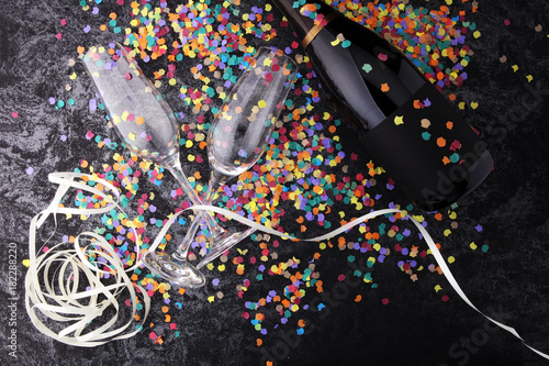 Party with champagne, glasses and confetti. New Year's Eve or birthday photo