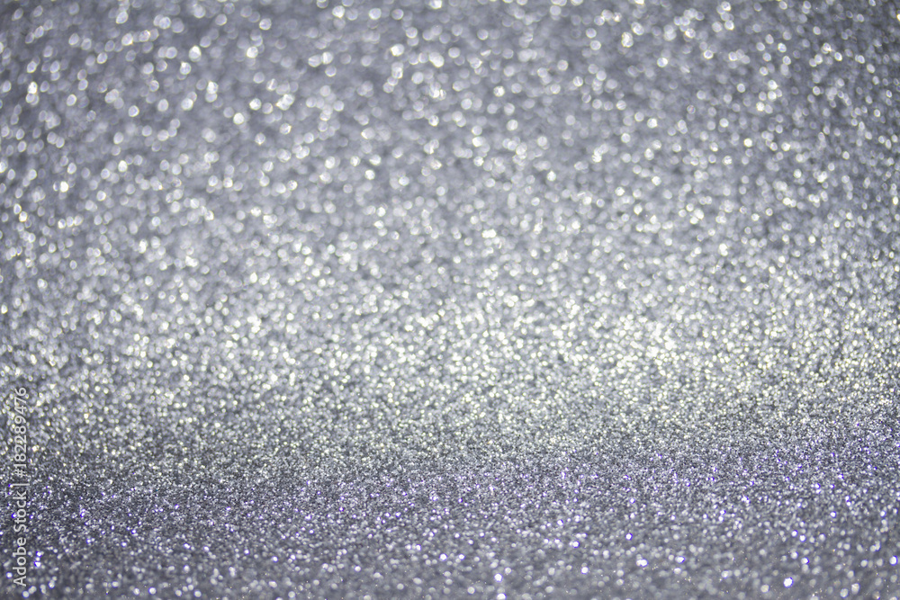 Christmas holiday festive glittering defocused gray background with bokeh