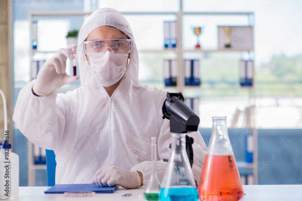 Chemist working in the laboratory with hazardous chemicals Chemist working in the laboratory with hazardous chemicals