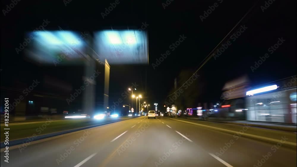 Time lapse of driving a car in the city at night time. POV. Hyper laps in the evening downtown. Time lapse of driving a car in the city at night time. POV. Hyper laps in the evening downtown.