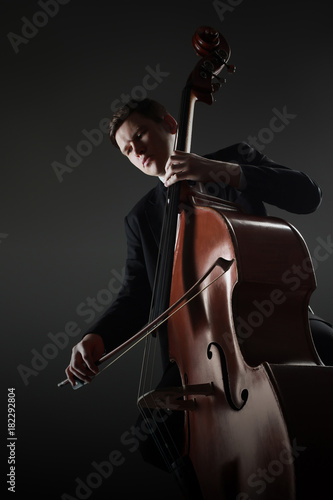 Fotografie Double bass player contrabass playing with bow