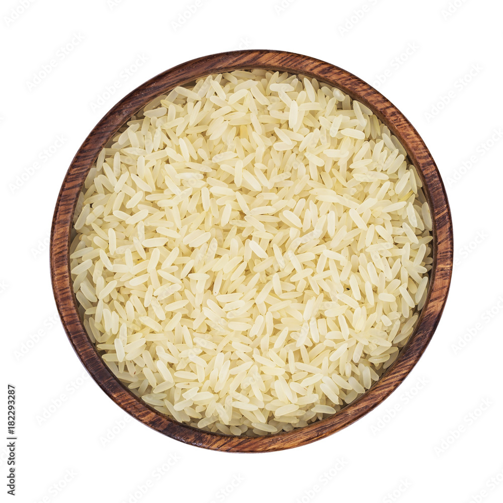 Parboiled rice in a wooden bowl isolated on a white background. Top view Parboiled rice in a wooden bowl isolated on a white background. Top view
