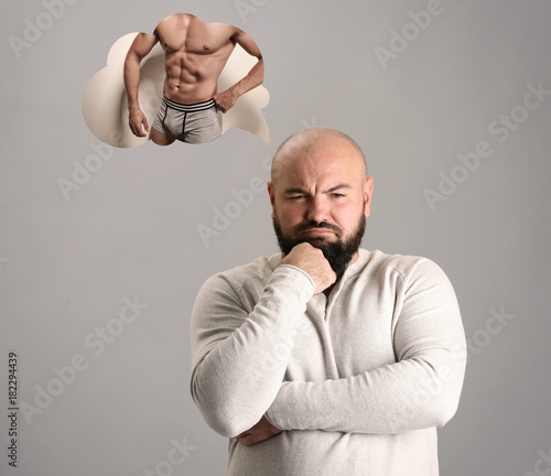 Overweight man dreaming abo...