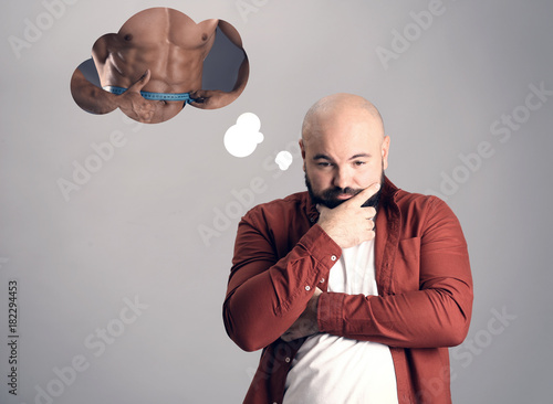Overweight man dreaming abo...
