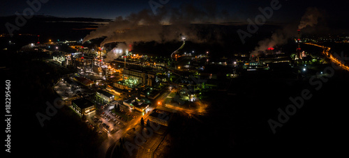 Aerial view of oil refinery. Industrial view at oil refinery plants with lots of light at night. Panorama.