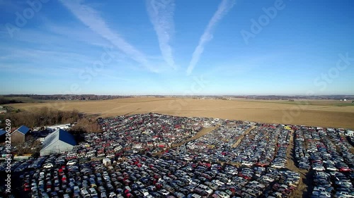 Waste and Planned Obsolesce - American Car Industry - Steel village and Car Wreckage Recycling - Aerial 4K Video photo