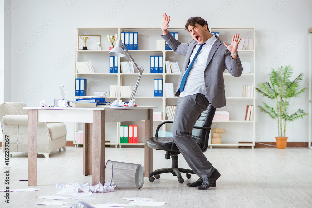 Businessman having fun taking a break in the office at work Businessman having fun taking a break in the office at work
