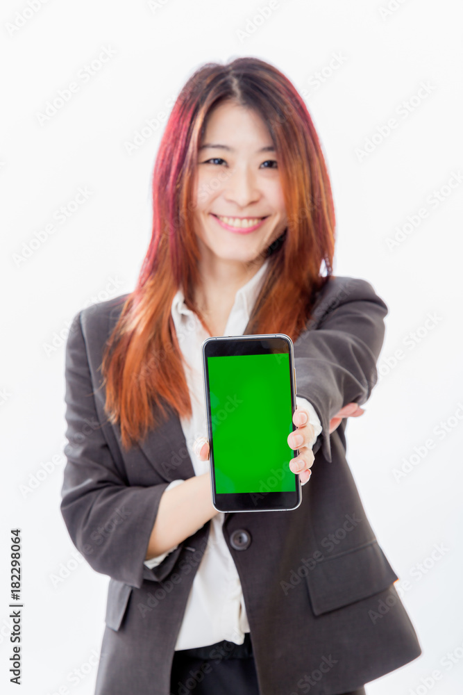 Defocused Asian woman holding out smartphone with green screen Defocused Asian woman holding out smartphone with green screen