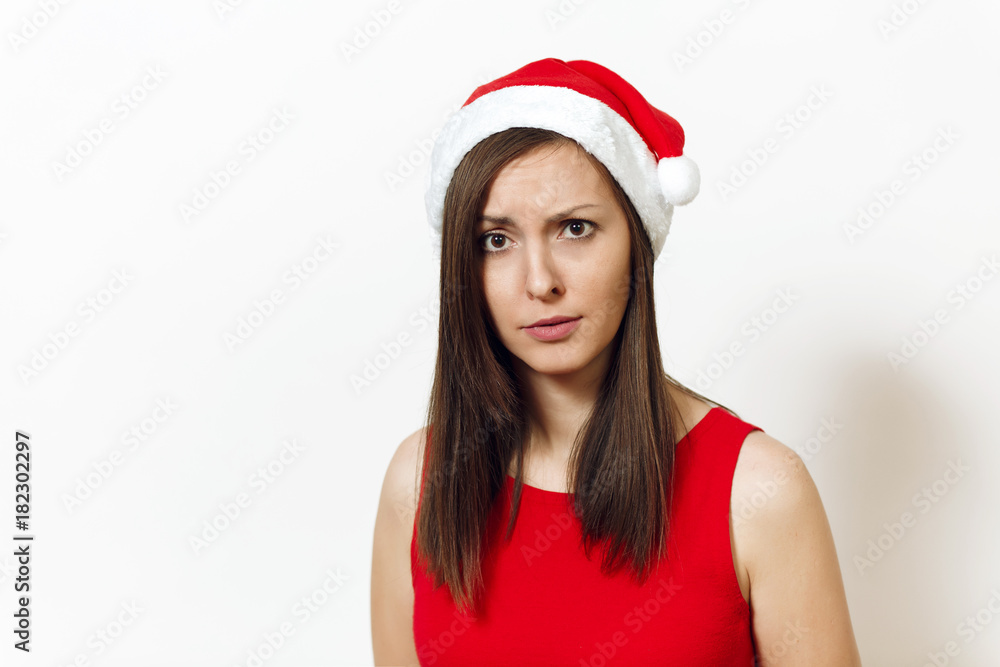 Beautiful caucasian young displeased and discouraged woman wearing red dress and Christmas hat on white background. Santa girl isolated portrait. New Year holiday 2018 concept Beautiful caucasian young displeased and discouraged woman wearing red dress and Christmas hat on white background. Santa girl isolated portrait. New Year holiday 2018 concept