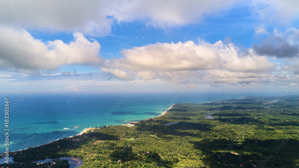 beautiful aerial shot of ocean coast and jungle side
