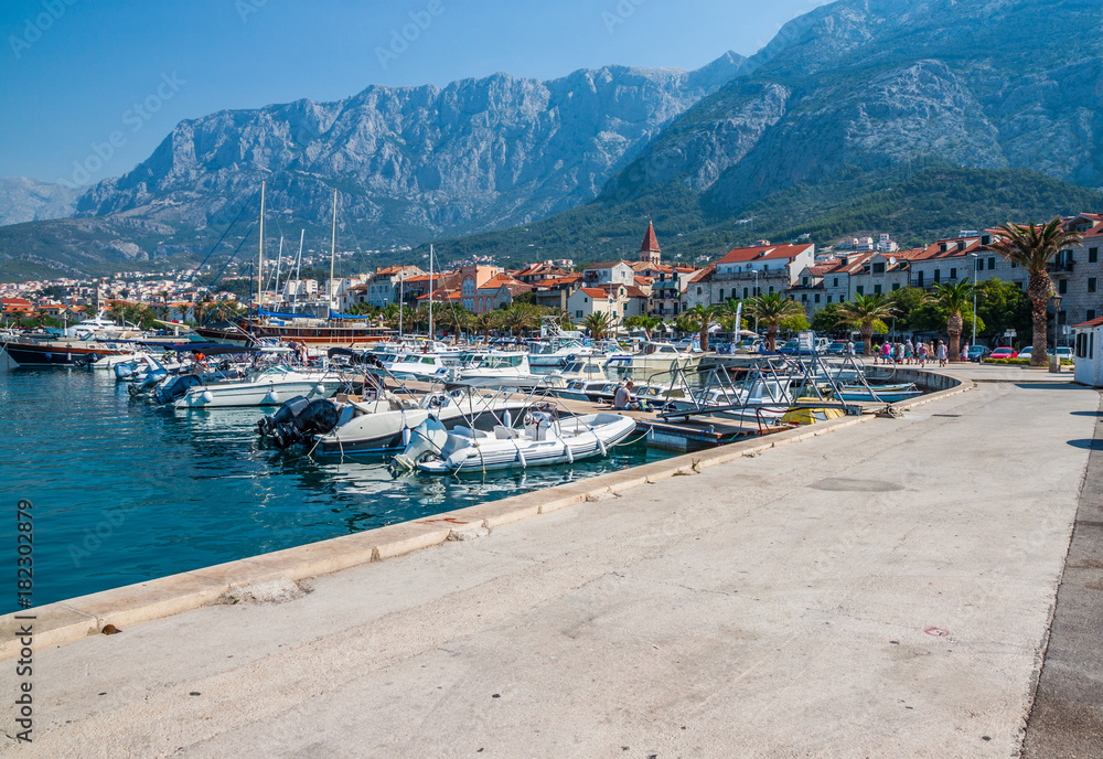 Motor boats parked at pier in Makarska city. Popular tourist destination. Croatia