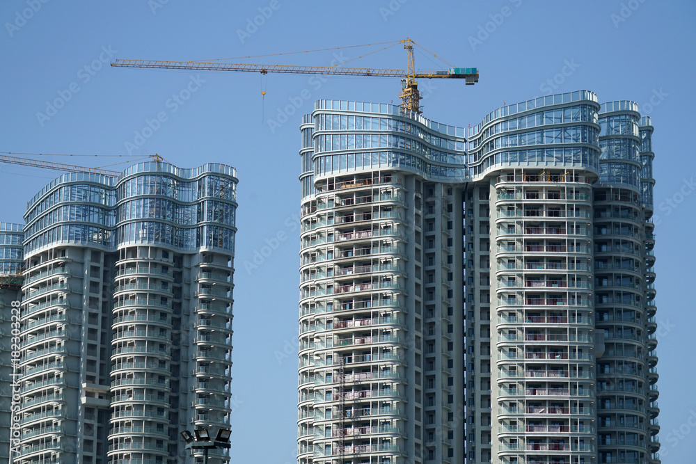 skyscraper building under construction with crane at construction site