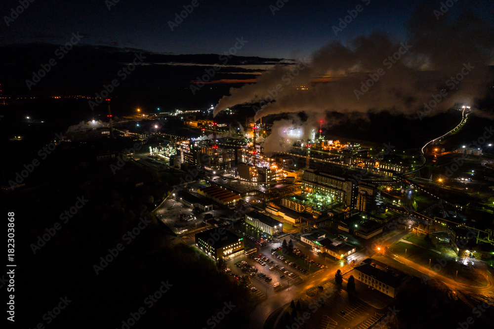 Fototapeta premium Aerial view of oil refinery. Industrial view at oil refinery plants with lots of light at night. 