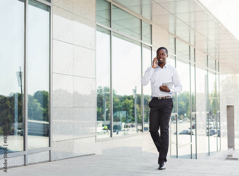 Black businessman outdoors in smart casual ware Black businessman outdoors in smart casual ware