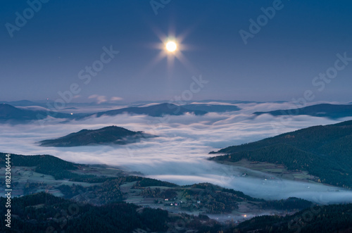 Misty mountains panorama in the night, full moon, Poland landscape, Beskidy range © tomeyk