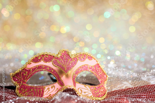 Fototapeta Naklejka Na Ścianę i Meble -  Pink carnival mask on bokeh background