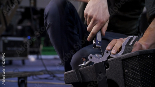 Close up of hands screwing together furniture pieces. Man screwing a screw with screwdriver.