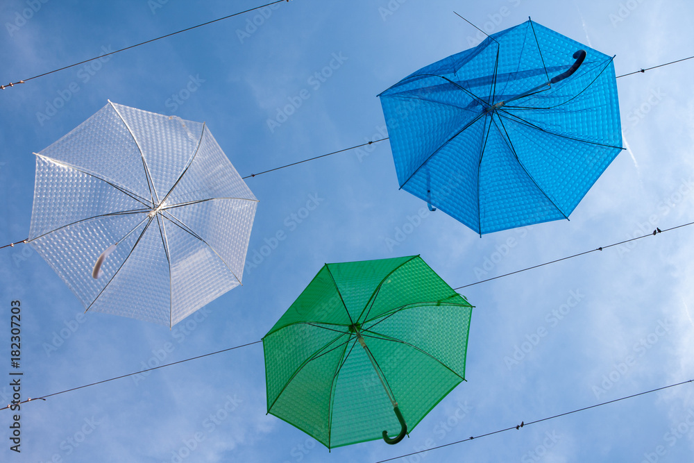 Street art with hanging blue, green and white umbrellas in Szentendre, Hungary Street art with hanging blue, green and white umbrellas in Szentendre, Hungary