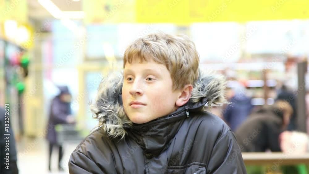 Boy in shopping center, selective focus with shallow depth of field.
Boy in shopping center, selective focus with shallow depth of field.