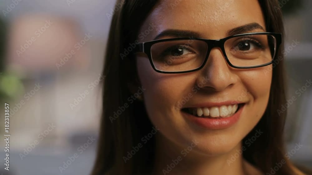 Close up portrait of attractivel woman in the glasses looking to the camera in the living room at home. Close up portrait of attractivel woman in the glasses looking to the camera in the living room at home.