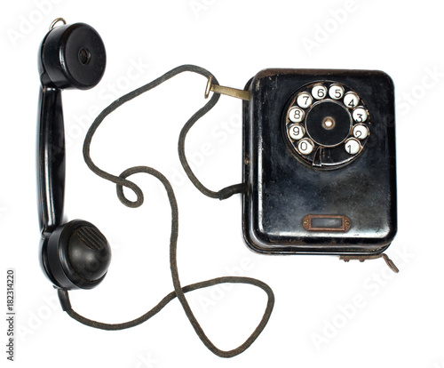 Black vintage phone and a receiver with a cord (isolated on white), top view