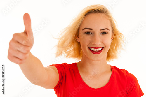 Attractive blonde woman shows thumb up as a gesture for success isolated over white background