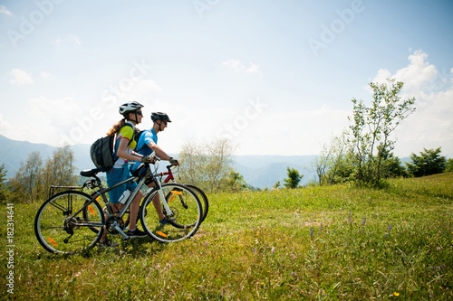 ACTIVE Young couple biking on a forest road in mountain on a spring day © Samo Trebizan