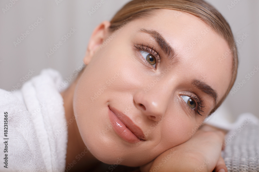 Close up of face of peaceful young woman dreaming while lying at beauty salon. Luxury concept Close up of face of peaceful young woman dreaming while lying at beauty salon. Luxury concept