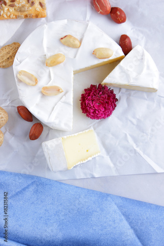 Cheese on white background, camembert, a glass of milk, Christmas cheese with honey, white background, blue napkin, pop art, red berries, Mexican cuisine, Indian cuisine, French breakfast