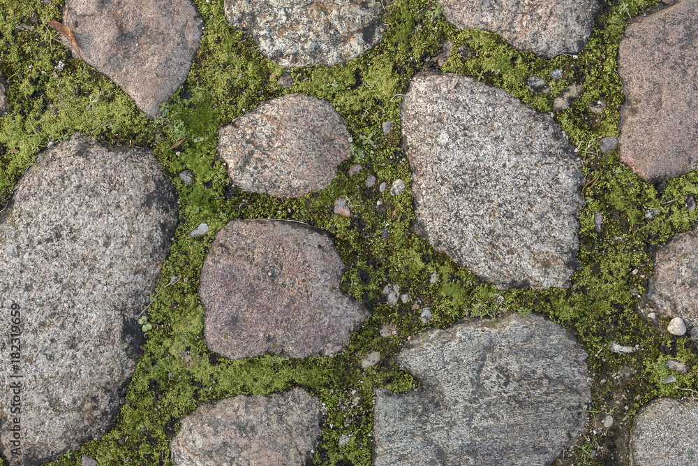 Fragment of the old road paved granite stones Fragment of the old road paved granite stones