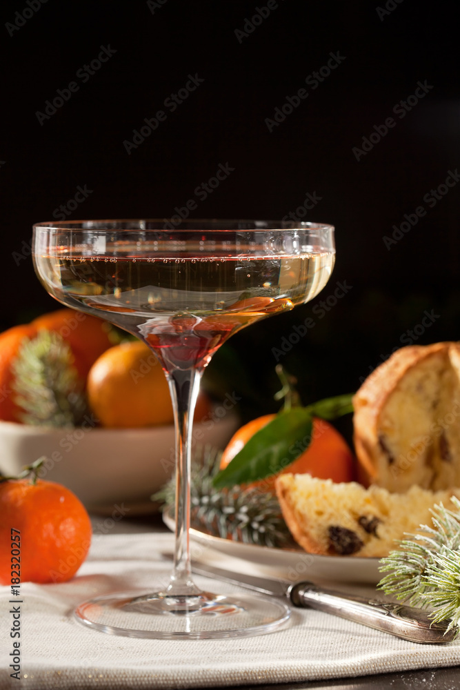 Winter holidays celebration with champagne and panettone traditional sweet italian dessert Winter holidays celebration with champagne and panettone traditional sweet italian dessert