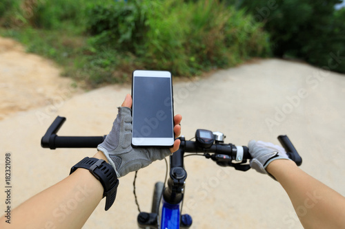 cyclist use smartphone for navigation in front of the Crossroads to choose the correct way
