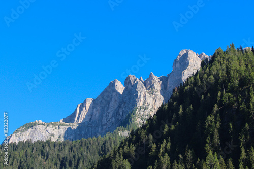 Landscape with green forest, mountains and blue sky. photo