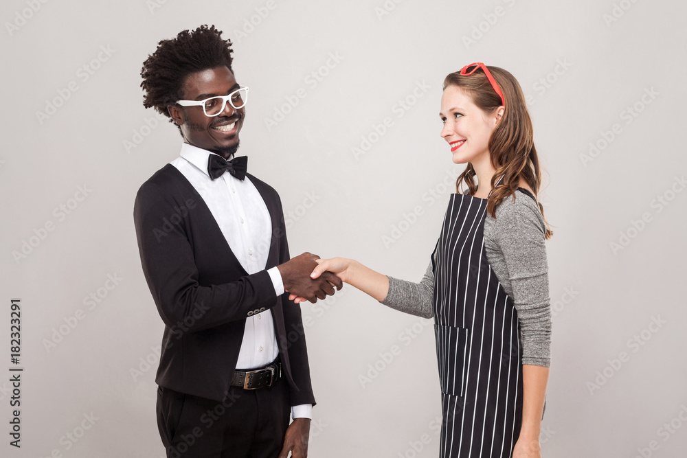 Φωτογραφία African man and freckles caucasian woman handshake and toothy smiling