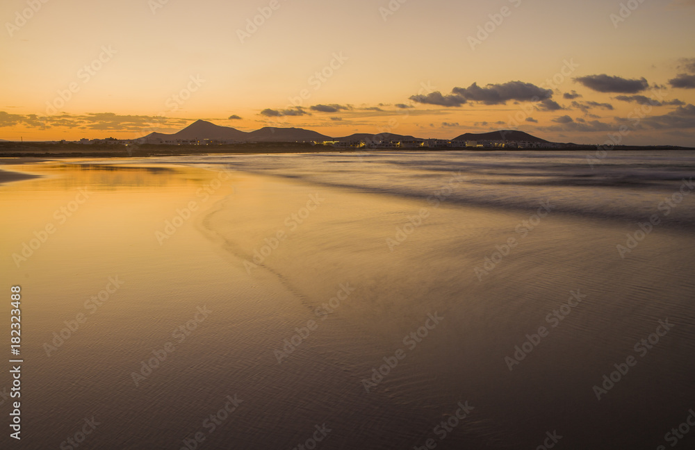 Caleta de Famara (Famara beach) шin Lanzarote island. Atlantic ocean. Beach view on Lanzarote Canary island in Spain Caleta de Famara (Famara beach) шin Lanzarote island. Atlantic ocean. Beach view on Lanzarote Canary island in Spain
