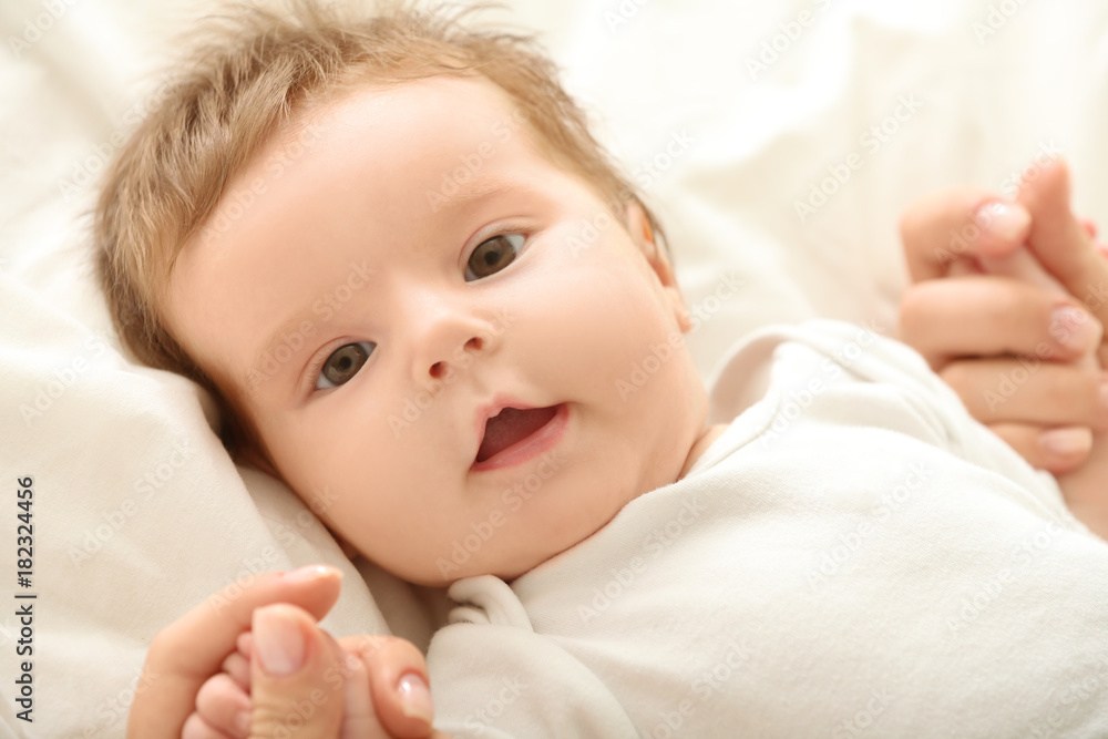 Cute little baby lying on bed at home Cute little baby lying on bed at home