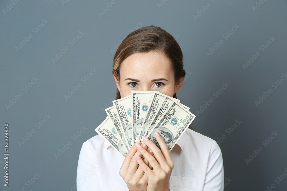 Beautiful young woman with money on color background Beautiful young woman with money on color background