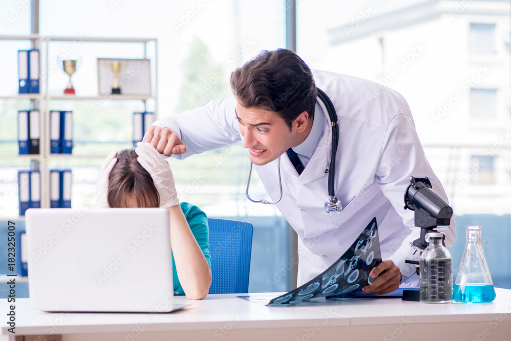 Two doctors discussing x-ray MRI image in hospital Two doctors discussing x-ray MRI image in hospital