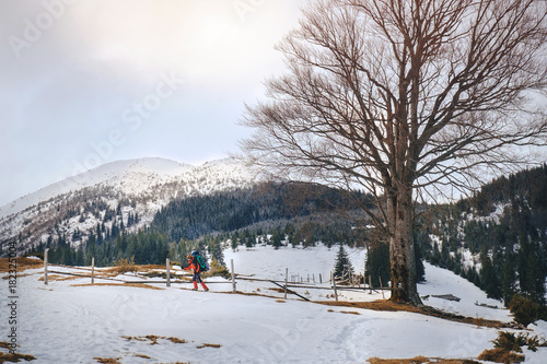 Man hiking in beautiful winter mountain