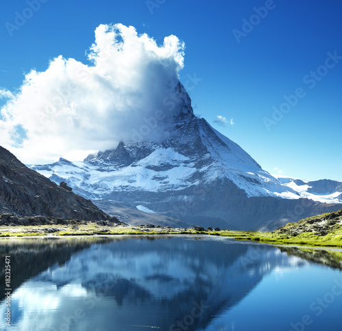 Fototapeta Naklejka Na Ścianę i Meble -  Reflection of Matterhorn in lake Riffelsee, Zermatt, Switzerland