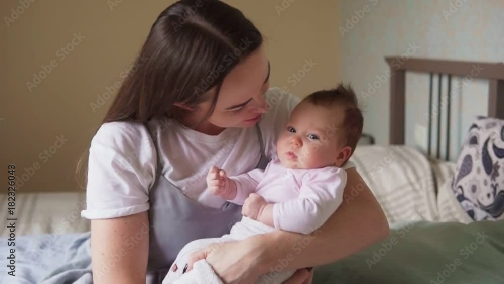 Happy mother caresses her newborn baby, slow motion Happy mother caresses her newborn baby, slow motion