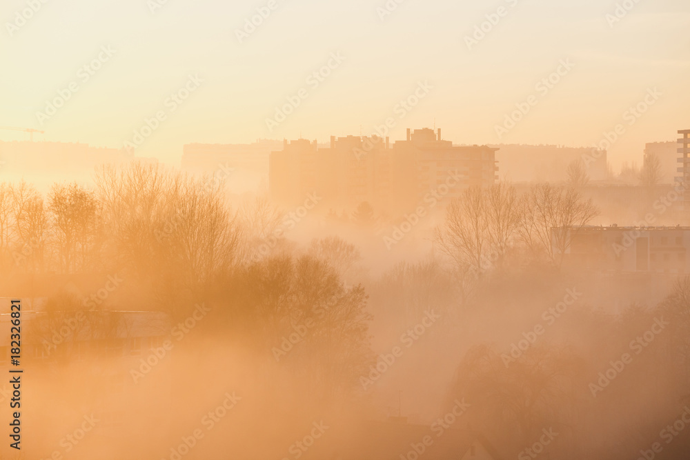 City at misty sunrise