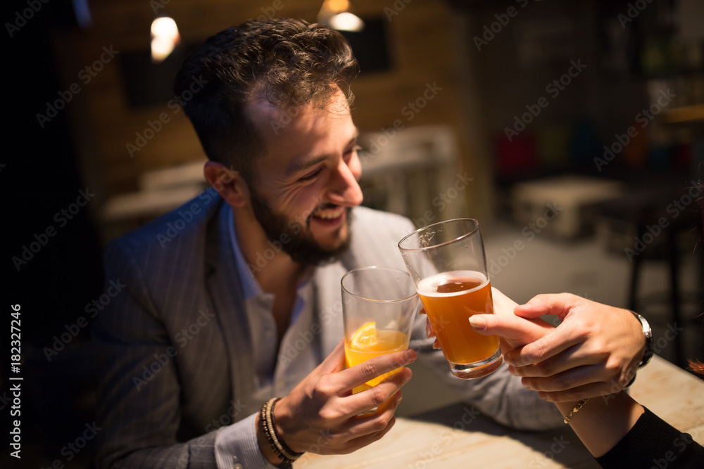 Man toast with craft beer in a pub