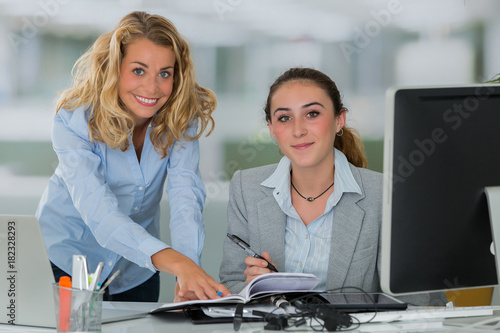 secratary an female boss in office photo