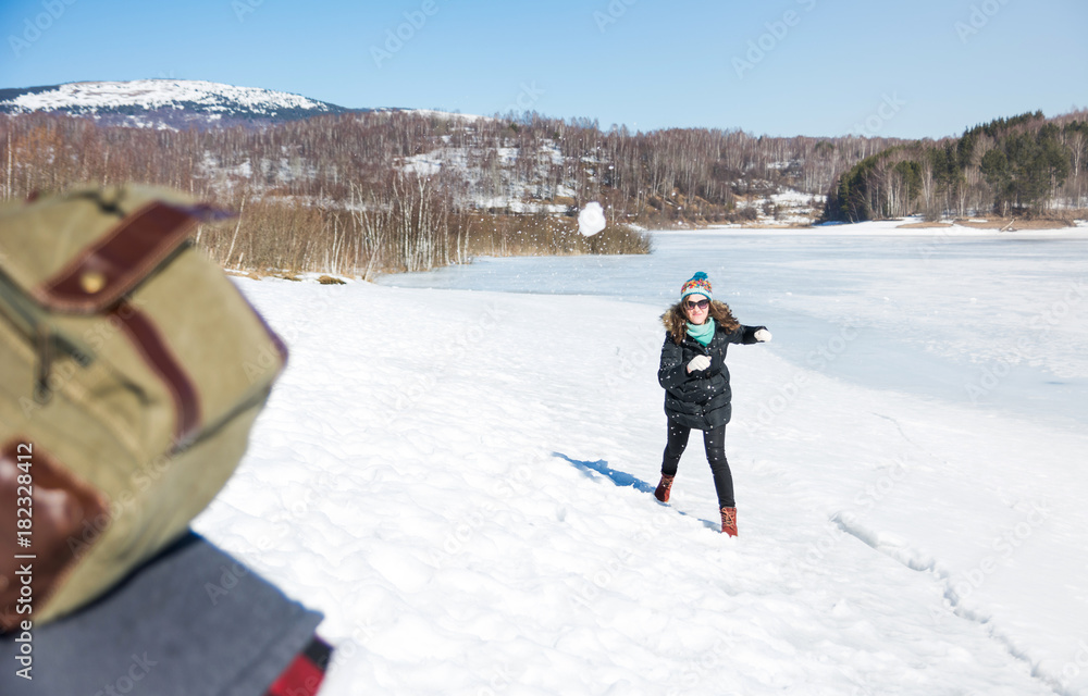 Couple snowball fighting and having fun