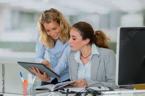 secratary an female boss in office photo