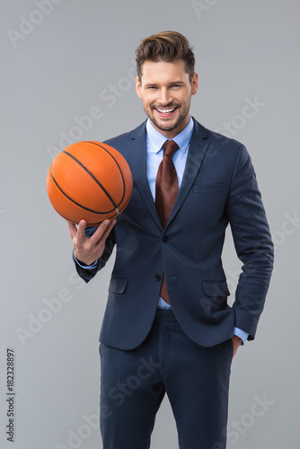 Happy elegant man with basketball. Business concept