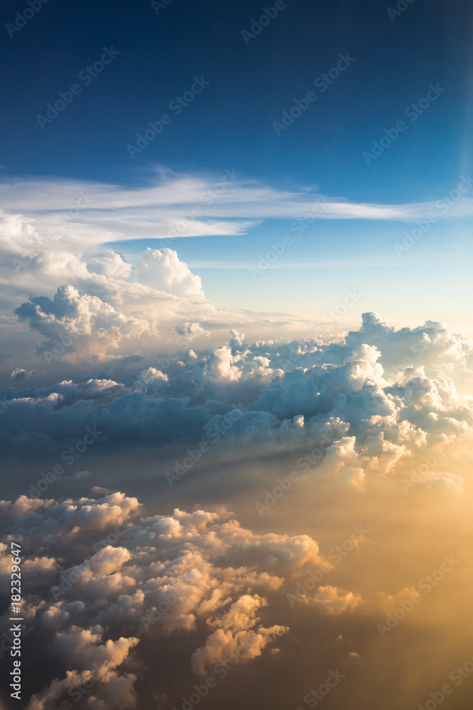 beautiful sunset above clouds from airplane window / sunset with a height of 11 000 km / sunlight through the clouds on sunset beautiful sunset above clouds from airplane window / sunset with a height of 11 000 km / sunlight through the clouds on sunset