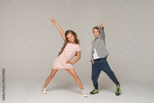 Happy dancing kids. Studio photo.